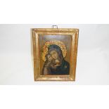 An early framed icon featuring the Virgin Mary, painted on tin.