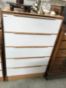 A tall teak chest of 5 drawers