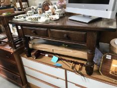 A dark brown coffee table with 2 drawers