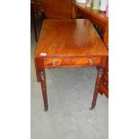 A mahogany Pembroke table on brass castors.