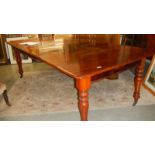 A mahogany extending dining table with 3 leaves.