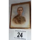 An early 20th century picture of a soldier on porcelain in a gilded frame, in good condition.