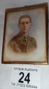 An early 20th century picture of a soldier on porcelain in a gilded frame, in good condition.