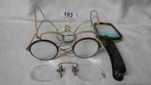 A mixed lot of old spectacles and magnifiers.