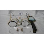 A mixed lot of old spectacles and magnifiers.