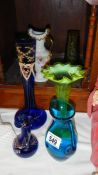 A quantity of coloured glass vases and jugs.