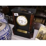 A black slate clock in working order.