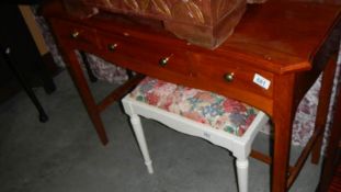 A 3 drawer mahogany side table.