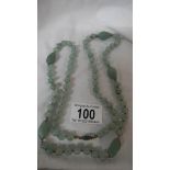 A double knotted jade necklace in good condition.