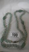 A double knotted jade necklace in good condition.