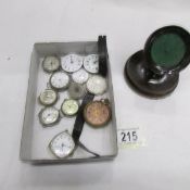 A mixed lot of pocket watch movements and a wooden pocket watch stand.