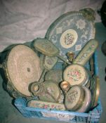 A box of dressing table items.