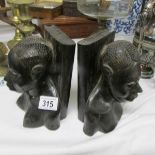 A pair of carved head bookends.