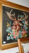 A framed and glazed tapestry depicting a stag.