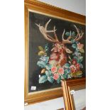 A framed and glazed tapestry depicting a stag.