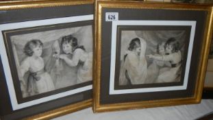 A pair of framed and glazed print depicting children.