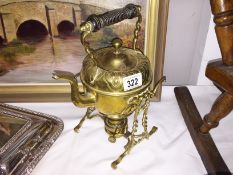 A brass kettle on stand.