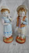 A pair of continental bisque porcelain figures, 10.5" tall.