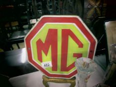 A metal MG plaque.