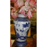 A blue and white willow pattern vase.