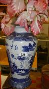 A blue and white willow pattern vase.