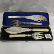 A cased pair of silver plate fish servers and one other pair.