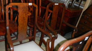 A pair of elbow chairs.