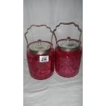 2 cranberry glass biscuit barrels.