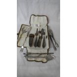 11 silver handled dressing table items.