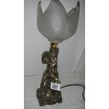 A cherub table lamp with glass shade.