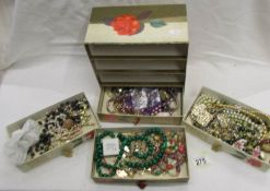 A mixed lot of costume jewellery in a card 4 drawer chest.