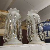 A pair of opaque glass lustres.