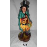 A Royal Doulton figurine 'The Mask Seller' in good condition.