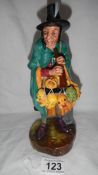 A Royal Doulton figurine 'The Mask Seller' in good condition.