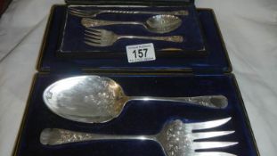 2 cased silver plate spoons and forks.