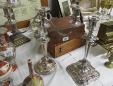 A silver plate candelabra and a silver plate candlestick,