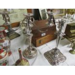 A silver plate candelabra and a silver plate candlestick,