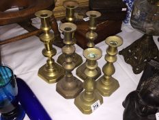 3 pairs of brass candlesticks.