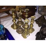 3 pairs of brass candlesticks.