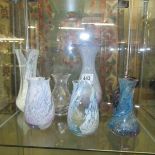 A quantity of coloured glass vases.