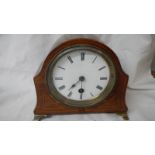 A mahogany inlaid mantel clock in good working order.
