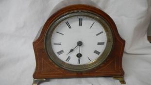 A mahogany inlaid mantel clock in good working order.