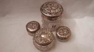 4 early 20th century sillver topped dressing table pots, all hall marked and in fair condition.