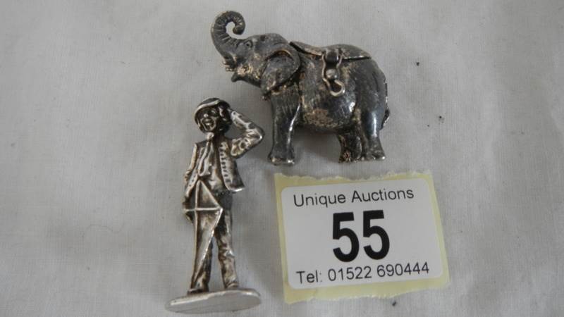 A hall marked silver figure and a silver plated pill box.