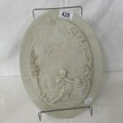 An oval cherub wall plaque.