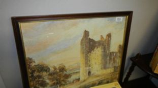 A framed and glazed watercolour of castle ruins.