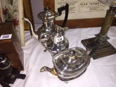 A silver plate teapot, coffee pot and water jug.