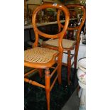 A pair of cane seated chairs.