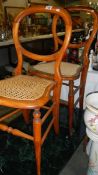 A pair of cane seated chairs.