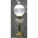 A brass oil lamp with glass font and later etched glass shade.